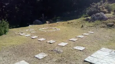 a garden with stepping stones on a hill at Aggeli Village House in Asklipiḯon