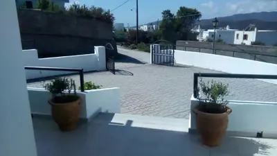 two potted plants sitting on the side of a balcony at Aggeli Village House in Asklipiḯon