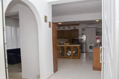 a kitchen with an archway leading into a living room at Aggeli Village House in Asklipiḯon
