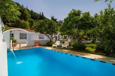 a swimming pool in the backyard of a house at Amelie Villa in Ixia