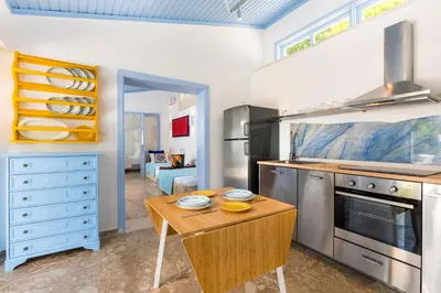 a kitchen with a table and a stove top oven at Amelie Villa in Ixia