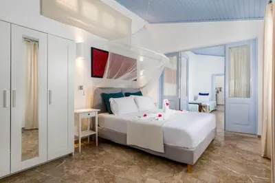 a bedroom with a large white bed in a room at Amelie Villa in Ixia