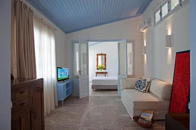 a living room with a couch and a television at Amelie Villa in Ixia