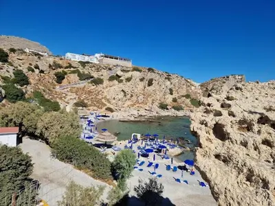 a group of blue umbrellas and a body of water at Casa di Mare Stegna in Archangelos