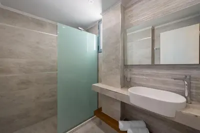 a bathroom with a sink and a mirror at Lardos Luxury Apartments in Lardos