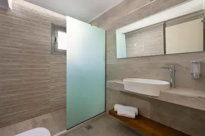 a bathroom with a sink and a mirror at Lardos Luxury Apartments in Lardos