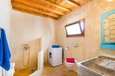 a bathroom with a tub and a toilet and a sink at The Grandma House in Ialyssos