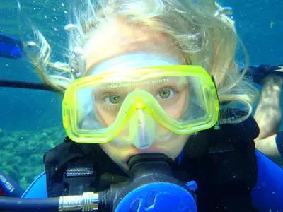a woman in a diver mask in the water at The Grandma House in Ialyssos