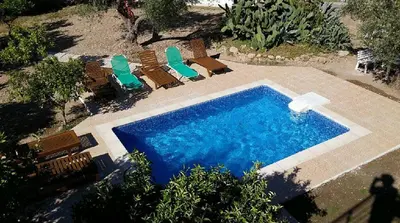 an overhead view of a swimming pool with chairs and a swimming pool at Villa Kaloudis in Kolimbia
