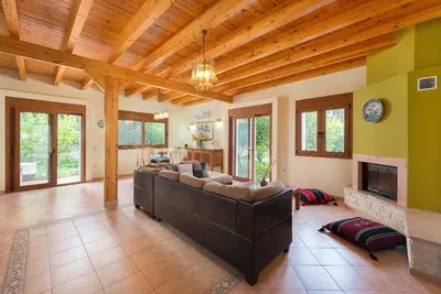 a living room with a couch and a fireplace at Villa Kaloudis in Kolimbia