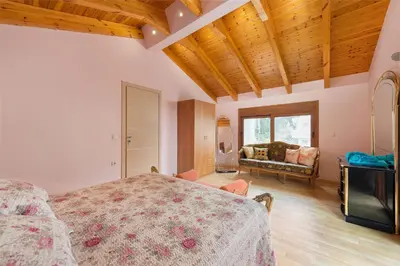 a bedroom with a bed and a couch in a room at Villa Kaloudis in Kolimbia