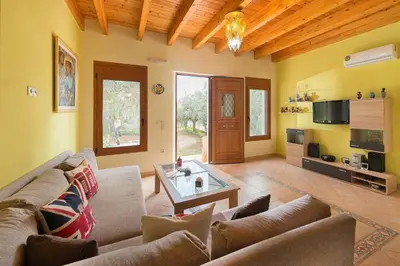 a living room with a couch and a table at Villa Kaloudis in Kolimbia