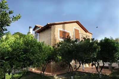 a brick house with trees in front of it at Villa Kaloudis in Kolimbia