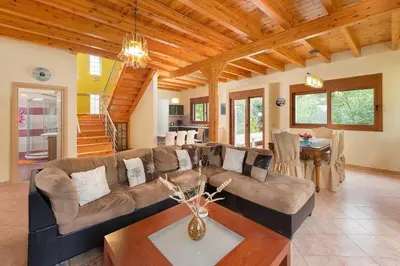 a living room with a couch and a table at Villa Kaloudis in Kolimbia