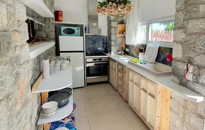 a kitchen with a white refrigerator and a stove at Pefkos Eye in Pefki Rhodes