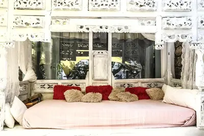 a white bed with a bunch of pillows on it at Pefkos Eye in Pefki Rhodes