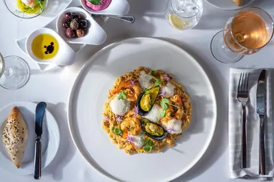 a white plate of food on a table at Atrium Palace Thalasso Spa Resort And Villas in Kalathos