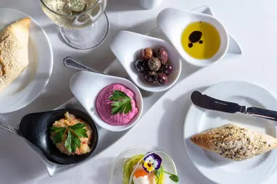 a white table with plates of food on it at Atrium Palace Thalasso Spa Resort And Villas in Kalathos