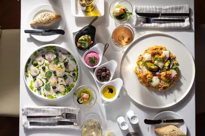 a white table with plates of food and bowls of food at Atrium Palace Thalasso Spa Resort And Villas in Kalathos