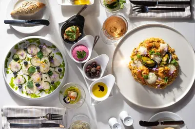 a table with plates of food and bowls of food at Atrium Palace Thalasso Spa Resort And Villas in Kalathos