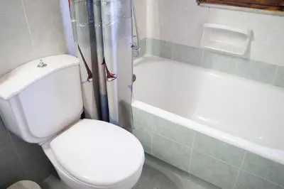 a bathroom with a toilet and a bath tub at M&B Luxury House in Theologos