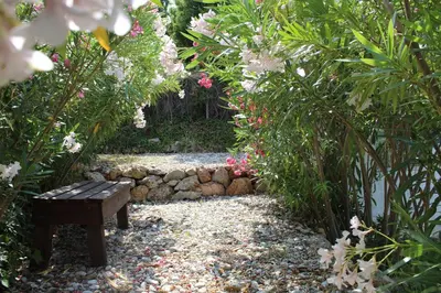 a bench in the middle of a garden with flowers at Salakos Mountain View Home in Sálakos