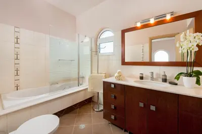 a bathroom with a tub and a toilet and a sink at MarySol Luxury Villa in Gennadi