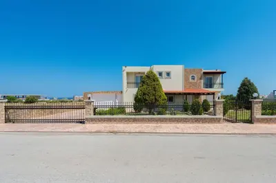 a house with a fence in front of it at MarySol Luxury Villa in Gennadi