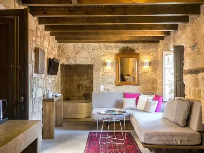 a living room with a couch and a table at Trinity Boutique Hotel in Rhodes Town
