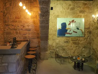 a bar with stools and a painting on the wall at Trinity Boutique Hotel in Rhodes Town