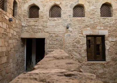 an old stone building with windows and a stone wall at Trinity Boutique Hotel in Rhodes Town