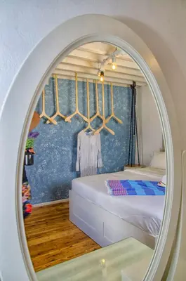 a mirror reflecting a bedroom with a bed in a room at Lindos Tholos Villa in Líndos