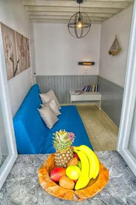 a room with a blue bed with a plate of fruit at Lindos Tholos Villa in Líndos