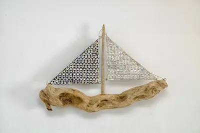a wooden model of a boat on a piece of driftwood at Lindos Tholos Villa in Líndos