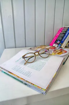 a pair of glasses sitting on top of a book at Lindos Tholos Villa in Líndos