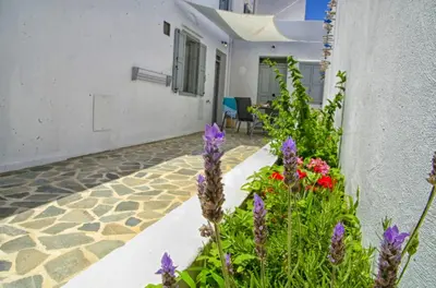 a garden with purple flowers next to a building at Lindos Tholos Villa in Líndos
