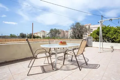 a white table and two chairs on a patio at EVA's House in Pastida