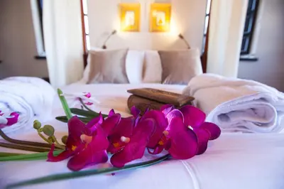 a bunch of purple flowers on a bed at Medieval Dreams Villa in Rhodes Town