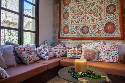 a living room with a couch with pillows and a candle at Medieval Dreams Villa in Rhodes Town