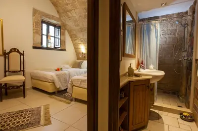 a bathroom with a sink and a shower and a bed at Medieval Dreams Villa in Rhodes Town
