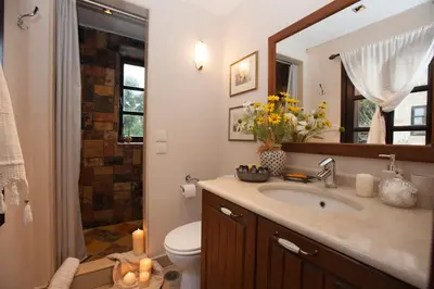 a bathroom with a sink and a toilet and a mirror at Medieval Dreams Villa in Rhodes Town