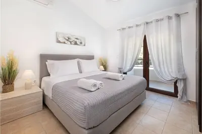 a bedroom with a bed with towels on it at Villa Leyland in Faliraki