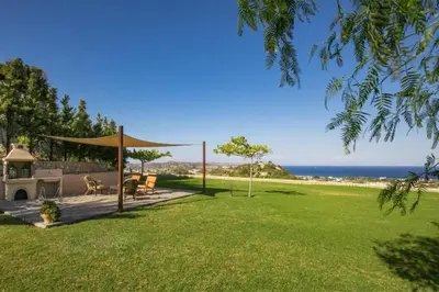 a backyard with a gazebo and the ocean at Villa Leyland in Faliraki