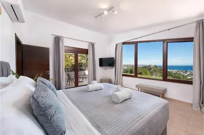 a bedroom with a bed with two towels on it at Villa Leyland in Faliraki