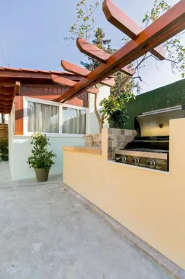 a barbecue grill in the backyard of a house at Green Apartments in Faliraki