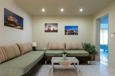 a living room with two couches and a table at Green Apartments in Faliraki