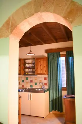 a kitchen with an archway and a sink in a room at Antifanous Apartments in Rhodes Town