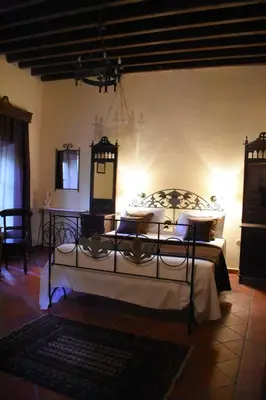 a bedroom with a bed and two tables in a room at Antifanous Apartments in Rhodes Town
