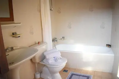 a bathroom with a toilet and a sink and a tub at Antifanous Apartments in Rhodes Town