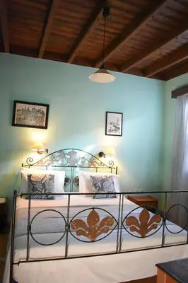 a bedroom with a bed with a metal frame at Antifanous Apartments in Rhodes Town